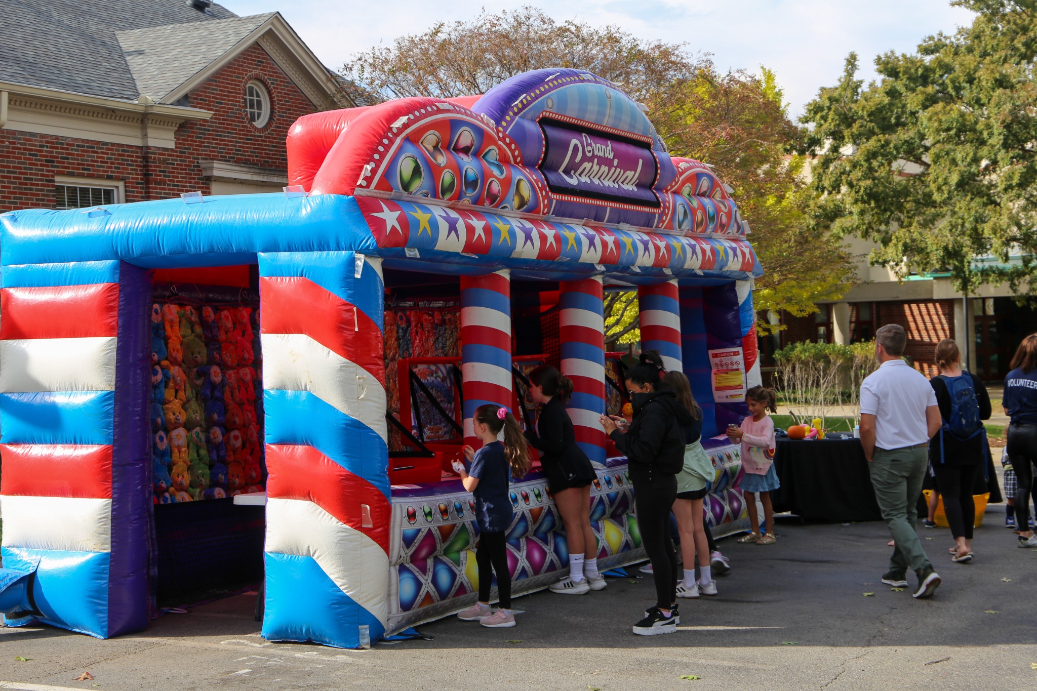 Children and families enjoying carnival games at Harding