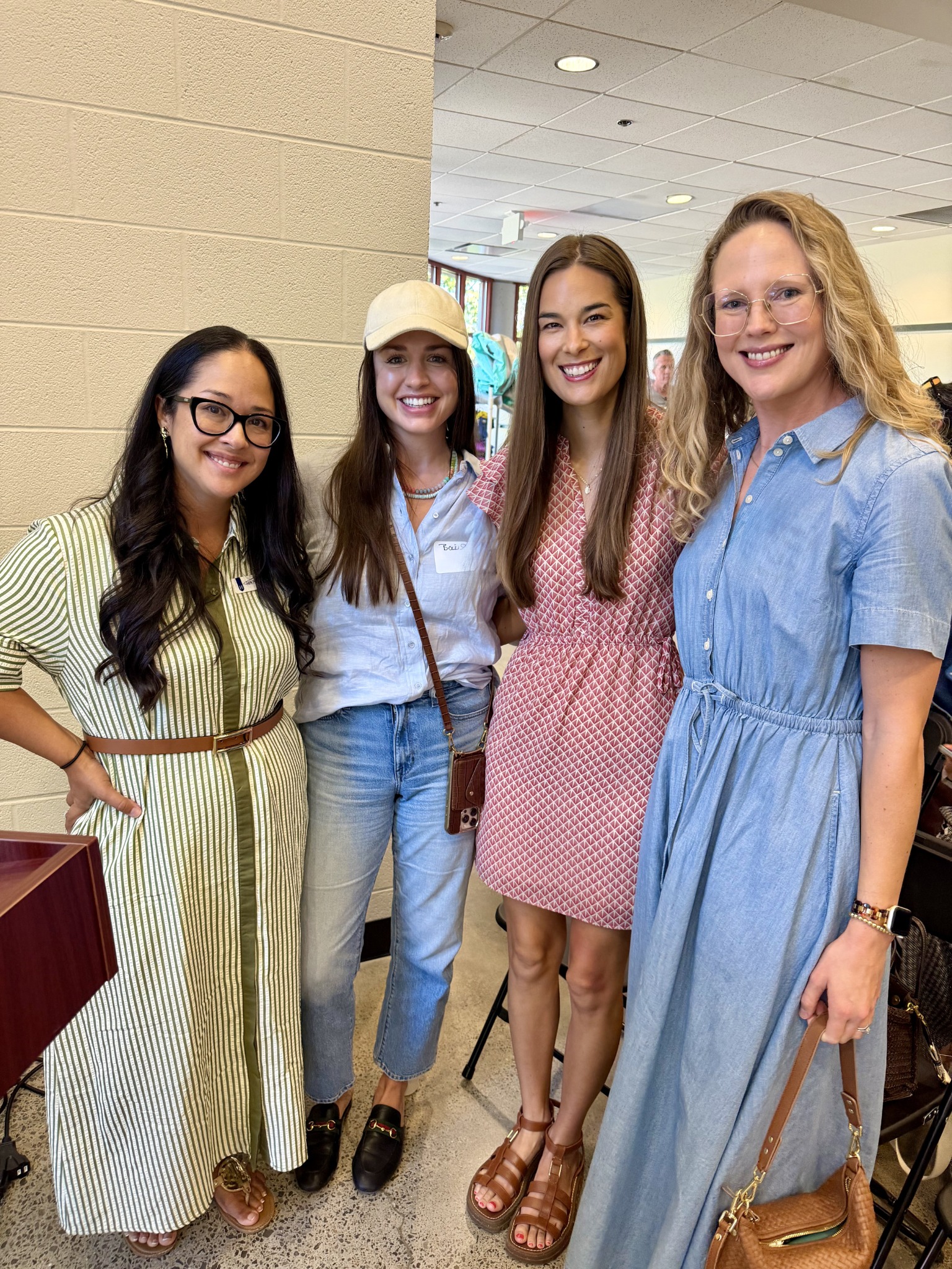 Four Harding parents smiling together at a school gathering
